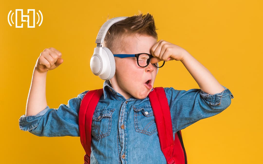 Little Kid Wearing Headphones and Backpack Flexing. Hurrdat Media Featured Photo