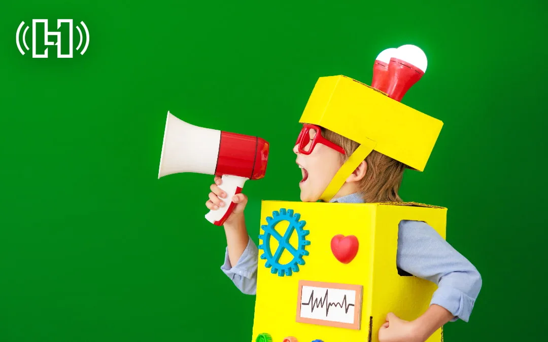 Featured Image for an Introduction to Programmatic Audio Advertising with child in yellow robot box costume yelling into a megaphone