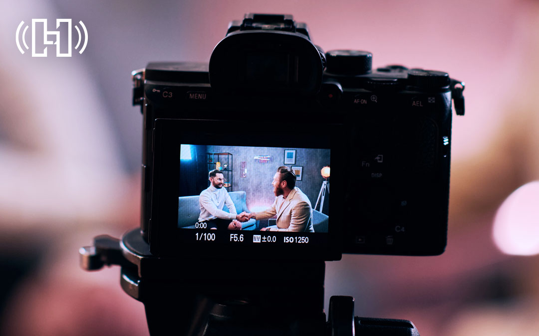 Video camera recording two people talking on a podcast